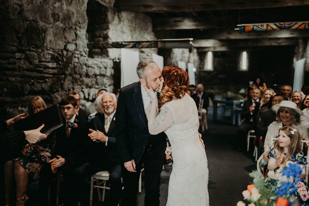 First kiss at Rushen Abbey documentary style wedding ceremony.
