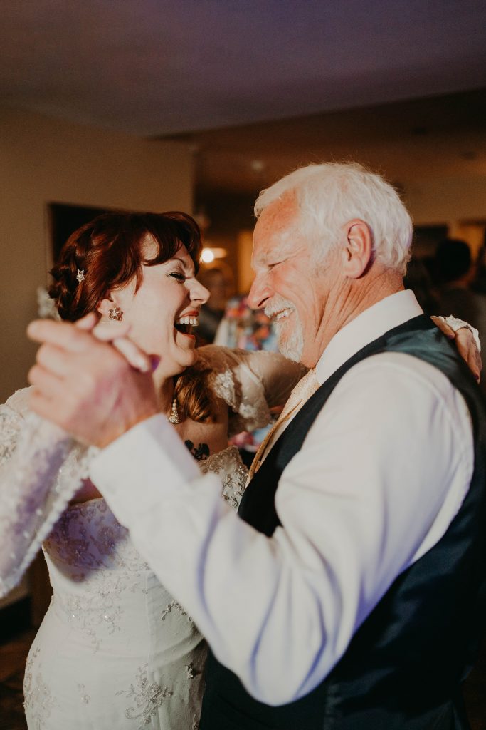 Bride and her dad dancing at Rushen Abbey documentary style wedding ceremony.