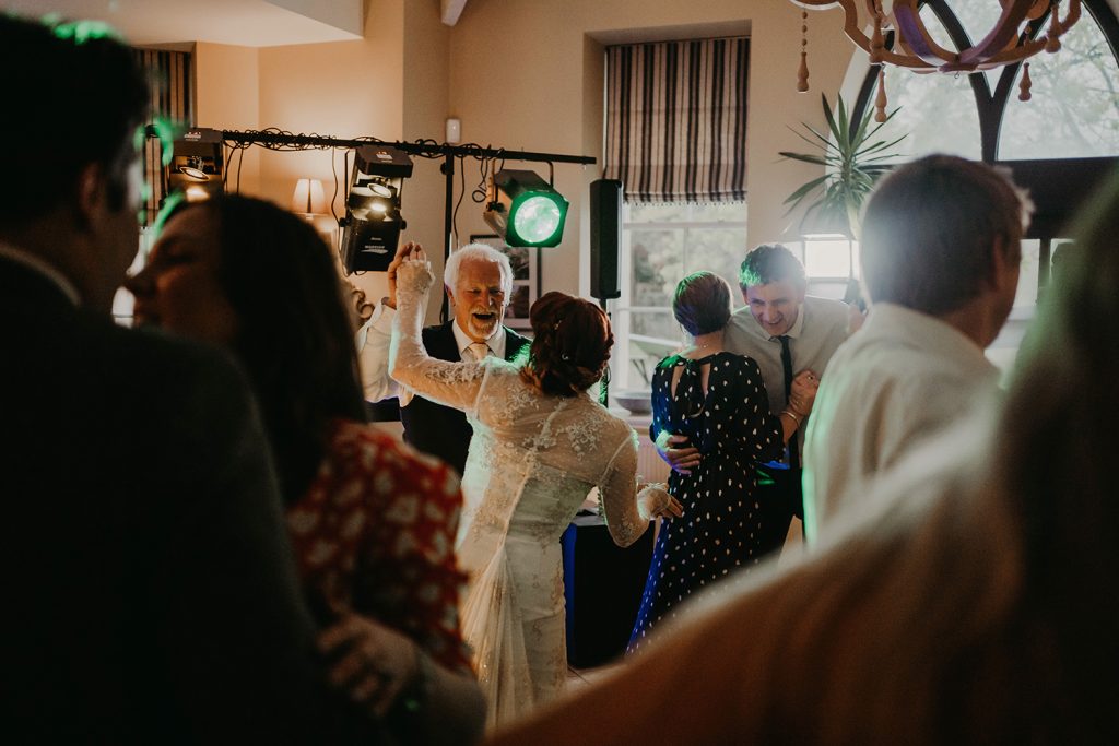 Bride and her dad dancing at Rushen Abbey documentary style wedding ceremony.