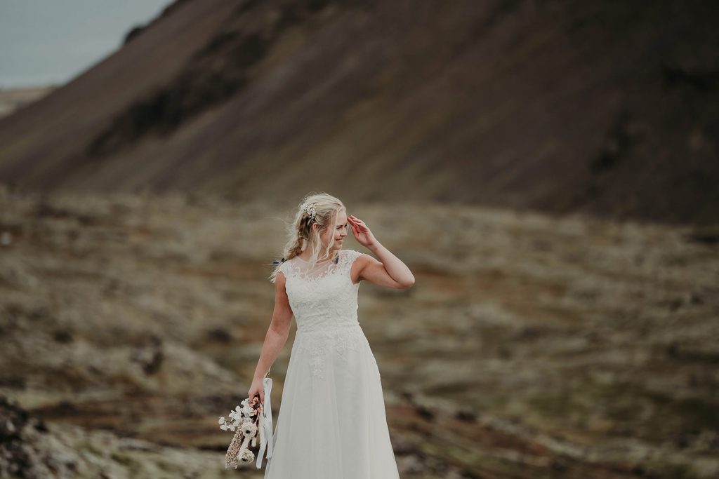 A bride with cliffs behind.